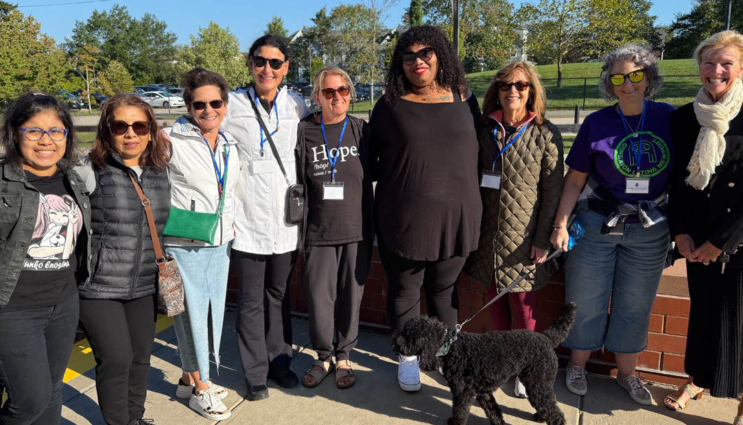 Volunteers standing outdoors posing for a group photo.